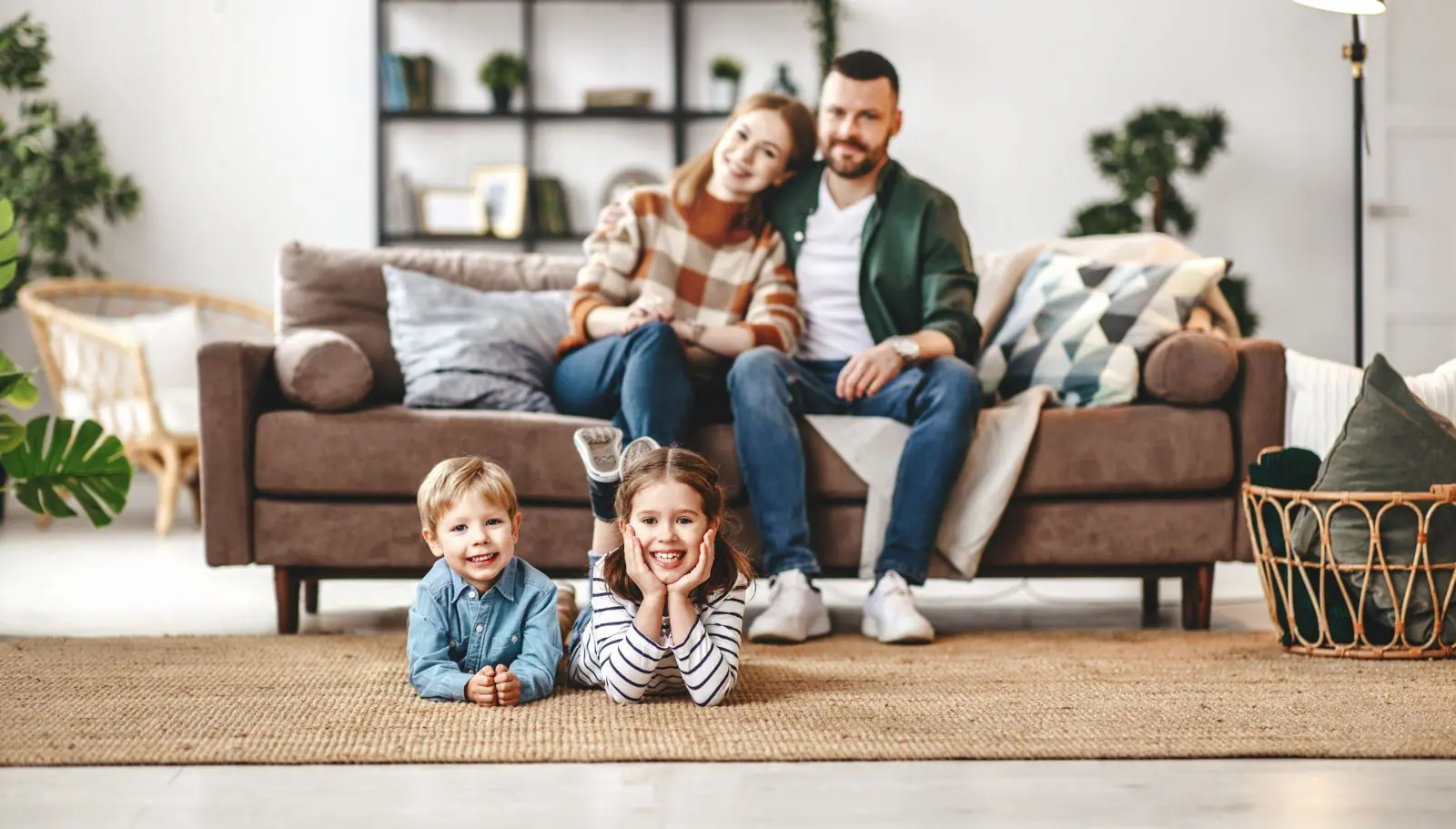 Mother, father, and children in living room of home