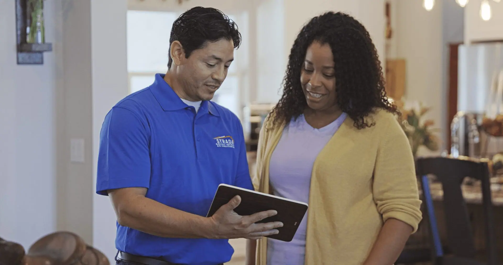 Strada Service technician talking with customer in home